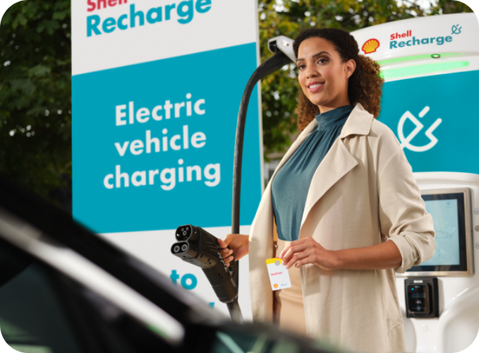 Driver using a Shell Recharge EV charging station with access to Shell Recharge roaming partners.