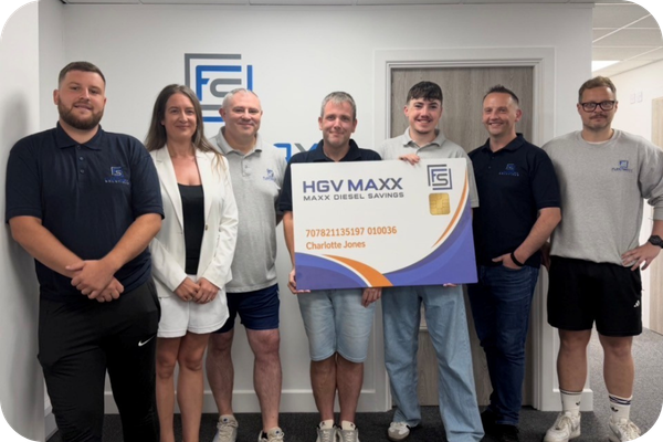 Tim Foort with the Fleetmaxx Solutions Northwich team of fuel and fleet cost reduction specialists holding an HGV Maxx diesel card.