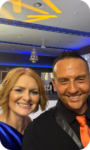 Fleetmaxx Business Development Manager Paul Maguire smiling with his wife at the Strictly Ballroom Manchester charity event.