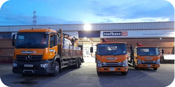 Three orange Roofbase delivery trucks parked outside a Roofbase roofing merchant branch.